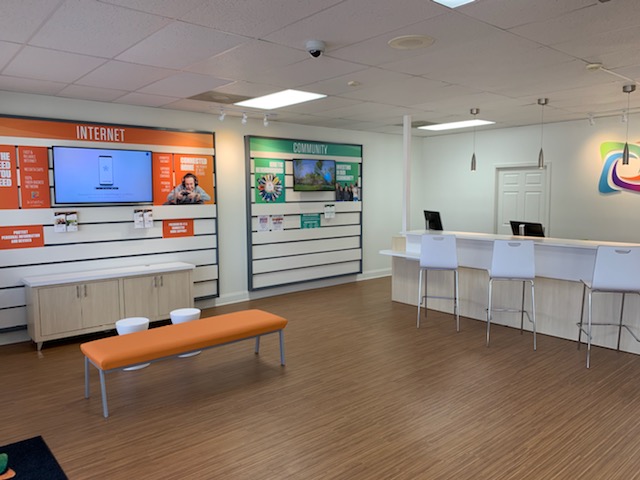 Retail interior with branded wall displays and a customer service counter